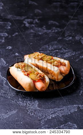 Photo Of Hotdogs On Black Plate At Table