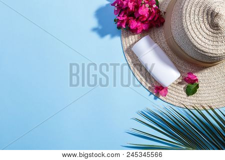 Summervacation, Beach Background With Hat, Bougainvillea Flowers, Cream And Palm Branch On Light Blu