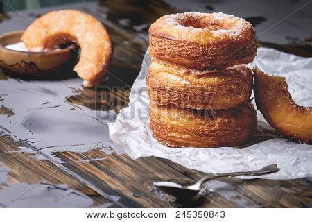 Homemade Puff Pastry Deep Fried Donuts Or Cronuts In Stack With Sugar Standing On Crumpled Paper Ove