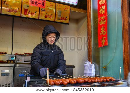 Harbin, China - Feb 22, 2018. A Vendor Selling Food On Walking Street In Harbin, China. Harbin Is La