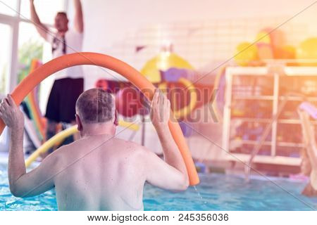 Group Or Young And Senior People In Aquarobic Fitness Swimming Pool Exercising Water Sport