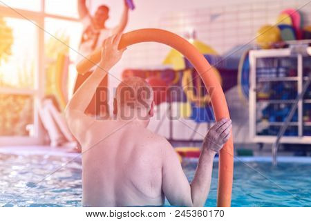 Group Or Young And Senior People In Aquarobic Fitness Swimming Pool Exercising Water Sport
