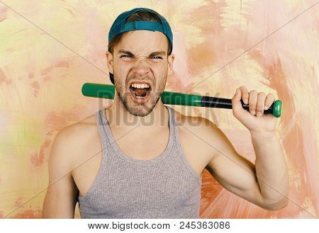 Guy In Grey Tank Top Holds Bright Green Bat. Player With Wild Rawring Face Plays Baseball. Man In Cy