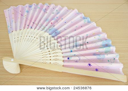 Paper Fan Lie On A Table