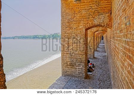Isfahan, Iran - May 8, 2015: People Resting And Enjoying The View Of The Zayandeh River From The Anc