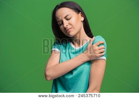 Pain Concept. Beautiful Female Portrait Isolated On Green Backgroud. Young Emotional Surprised Woman