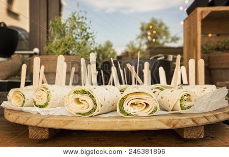 Healthy Turkey Wrap Sandwiches With Lettuce, Ham, Cheese And Cream Servde In Restaurant On A Wooden 