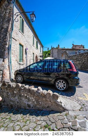 Arka Petrarka, Italy - June, 13, 2018: car stands on a parking in an old town in Arka Petrarka, Italy