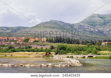 River Bank With Small Dam And Water Wheel. Bosnia And Herzegovina, Trebinje Town,  View Of Trebisnji