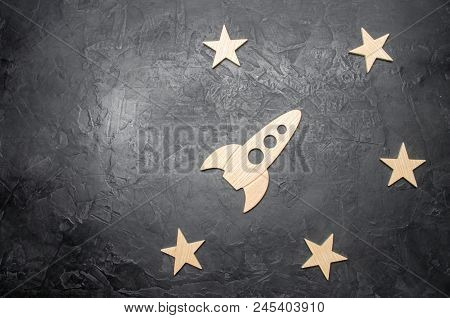 Wooden Space Rocket And Stars On A Dark Background. The Concept Of Space Travels, The Study Of Plane