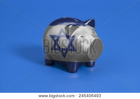 Piggy Bank With Flag Of Israel On Blue Background