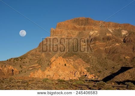 Beautiful View Of The Mountain Ridge At Sunset With Full Moon On The Background. Teide National Park