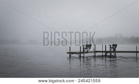 Dock With Benches On Foggy Lake Irving In Bemidji Minnesota