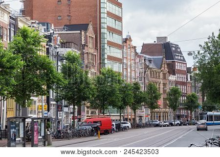 Amsterdam, Netherlands - June 25, 2017: View Of The Historical Buildings On The Nieuwezijds Voorburg
