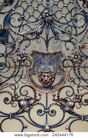Details, Structure And Ornaments Of Forged Iron Gate. Decorative Ornamen With Lions , Made From Meta