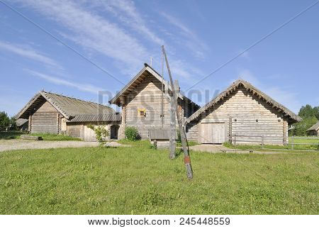 Old Peasant Houses With A Well (xviii Century). Pskov Region, Russia