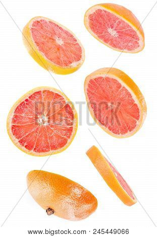 Creative Concept With Flying Grapefruit. Sliced Grapefruit Isolated On White Background. Levity Frui