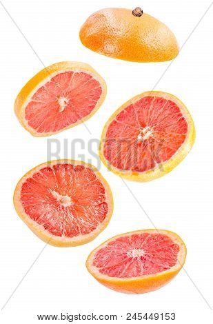 Creative Concept With Flying Grapefruit. Sliced Grapefruit Isolated On White Background. Levity Frui