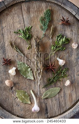 Aromatic Still Life With Various Herbs And Spices On Wooden Barrel, Top View, Close-up, Selective Fo