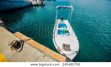 The old fishing boats are waving on the waves. Shipyard  in Limassol, Cyprus,  august 2017