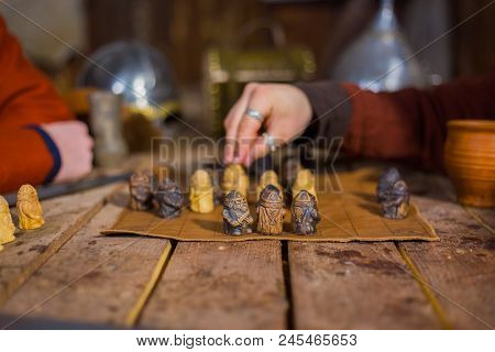 Close Up Shot - Two Men In Russian Ethnic Suit Playing Medieval Popular Strategy Board Game - Tafl. 