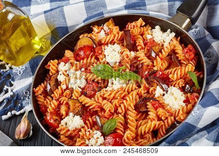 Italian Pasta Fusilli Alla Norma With Eggplant, Tomatoes, Basil, Ricotta Cheese In A Skillet With In