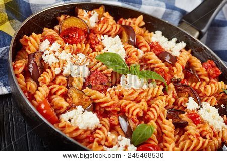 Vegetarian Italian Pasta Fusilli Alla Norma With Eggplant, Tomatoes, Basil, Ricotta Cheese In A Skil