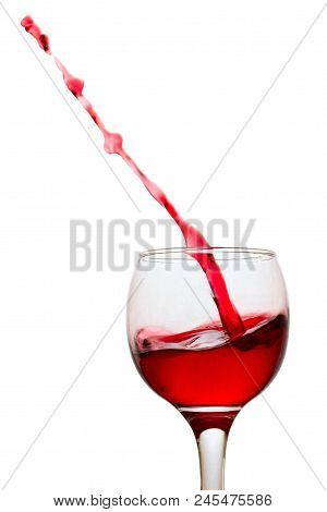 Thin Stream Of Red Wine Beautiful Splash In A Glass On A White Background Concept Of An Aperitic Alc