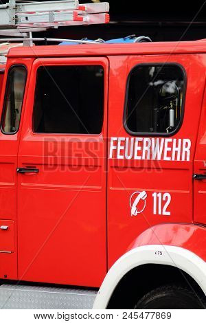 Bright Red German Emergency Car With Inscription Notruf 112 And Number Sign For Call. Fire Departmen