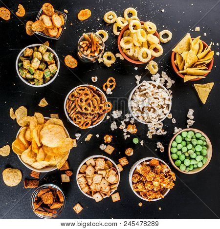 Variation Different Unhealthy Snacks Crackers, Sweet Salted Popcorn, Tortillas, Nuts, Straws, Bretse