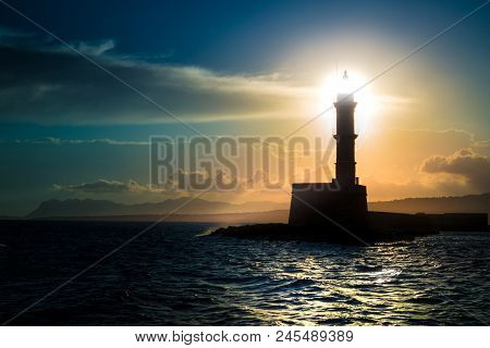 A Beautiful Night Sky Behind A Shining Lighthouse. Chania, Crete, Greece
