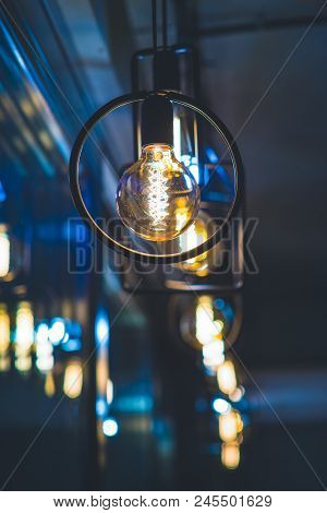 Vintage Tungsten Filament Multiple Lamps Of Different Size Hanging From The Ceiling. Interior Design
