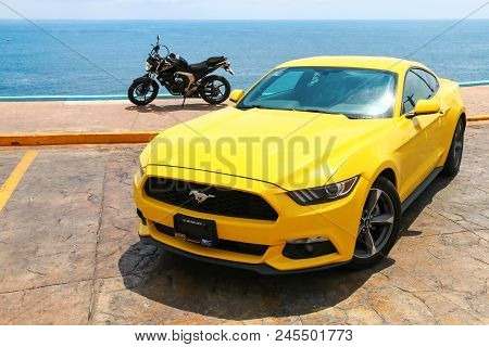 Acapulco, Mexico - May 31, 2017: Yellow Muscle Car Ford Mustang And Naked Bike Yamaha Fz25 In The Ci