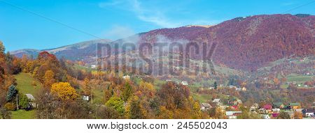 Autumn Carpathian Mountains Panorama Landscape With Multicolored Trees And Small Hamlet On Slope, An