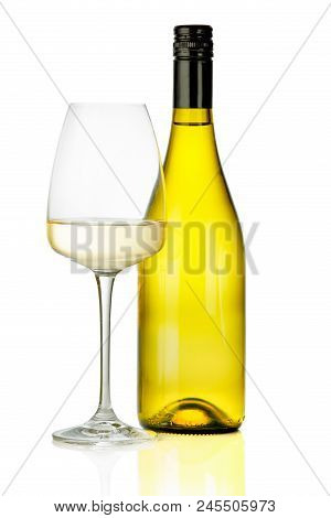 A Glass Of White Wine And A Bottle.