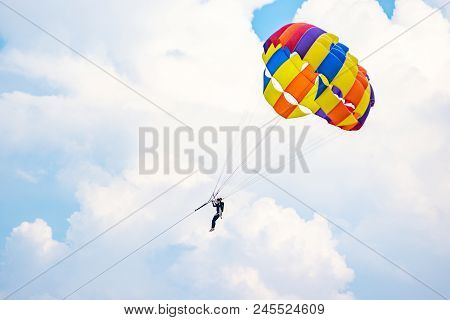 People Playing Parashoot On The Sky Summer Season