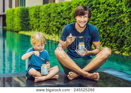 Father And Son Eat Dessert With Chia Seeds And Mangoes By The Pool In The Morning. Healthy Eating, V