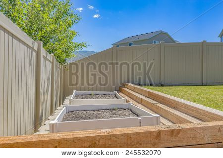 Growbeds In Clean Backyard With Lawn In Utah Valley