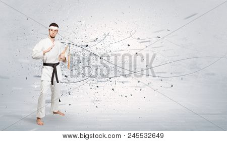 Young karate trainer doing karate tricks with chaotic concept