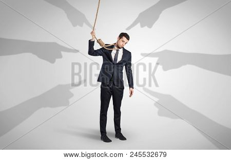 Young businessman trying to suicide with pointing hands concept