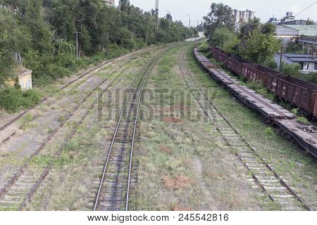 Boring Indistrial Landscape. Industrial Scene With Railway Platfform And Railway Junction.