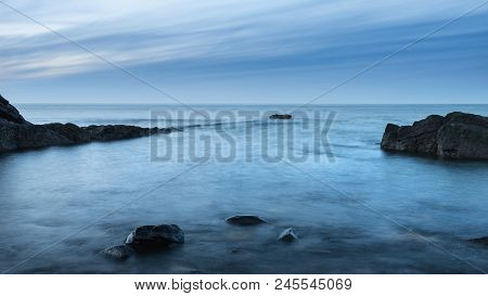 Beautiful Long Exposure Landscape Image Of Beach At Dunstanburgh In Northumberland