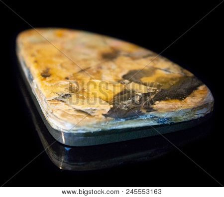 Natural Polished Yellow Simbercite On A Black Background Macro