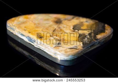 Natural Polished Yellow Simbercite On A Black Background Macro
