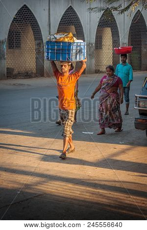 Unidentified Man Carryng Weight On His Head - A Bucket Full Of Fresh Fish