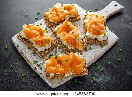 Homemade Crispbread Toast With Smoked Salmon And Soft Chees, Chives On White Board.