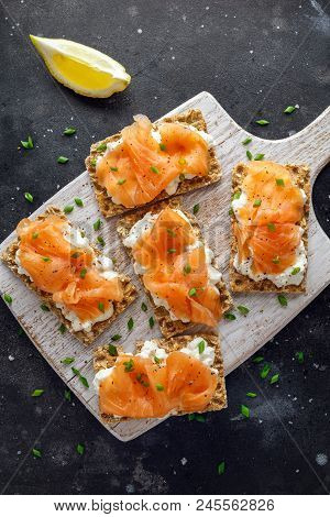 Homemade Crispbread Toast With Smoked Salmon And Soft Chees, Chives On White Board.