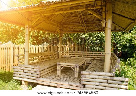 Bamboo Table And Seats Under A Bamboo Canopy With A Sunny Beams