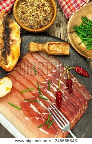 Thinly Sliced German Black Forest Ham With Sliced Ciabatta Bread. Sliced And Smoked Ham With Schwarz