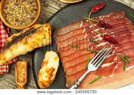 Thinly Sliced German Black Forest Ham With Sliced Ciabatta Bread. Sliced And Smoked Ham With Schwarz